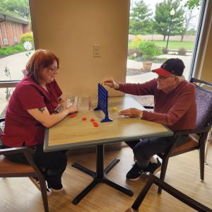 activities employee playing checkers with resident